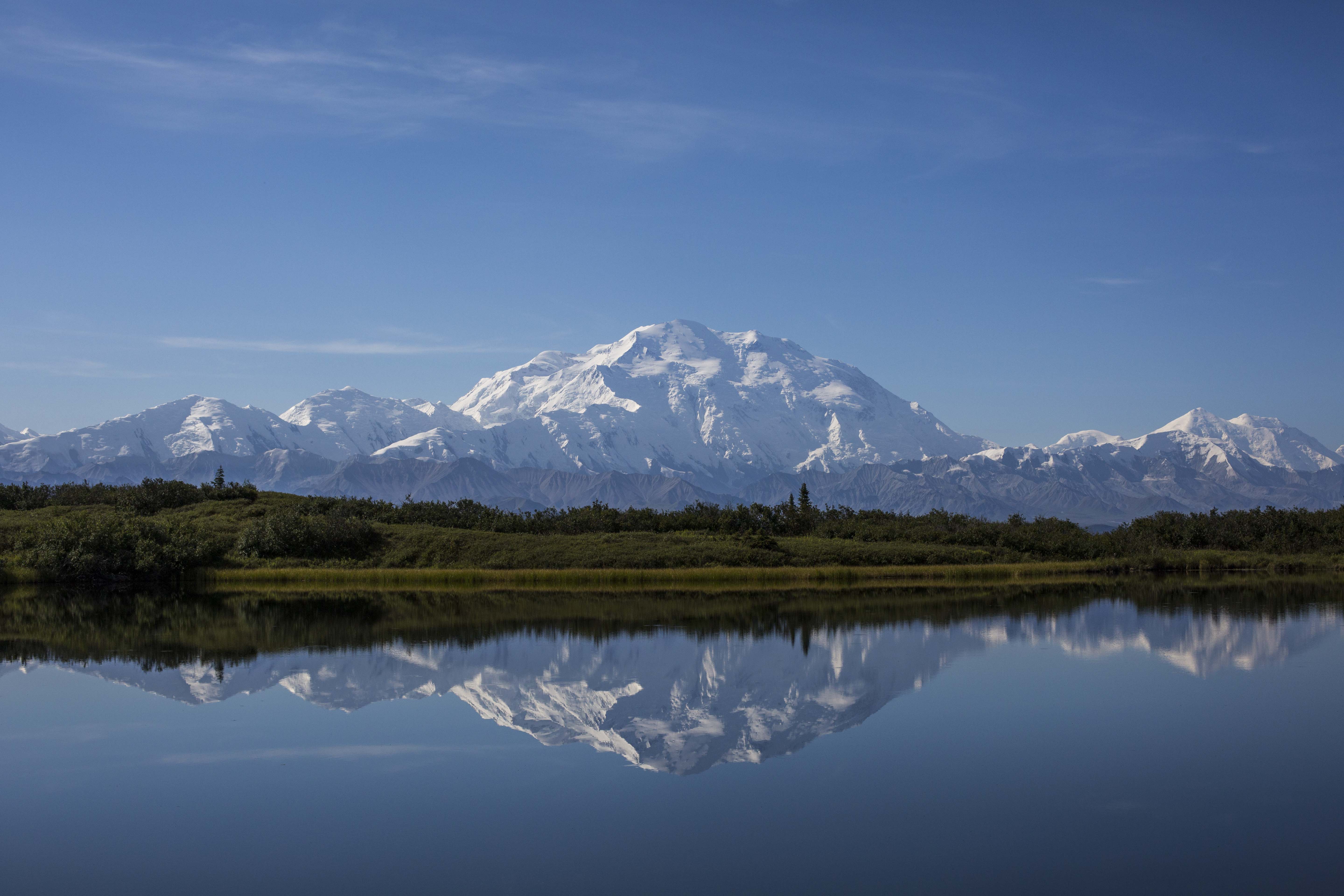 Majestic snow-capped Denali mountain (formerly Mount McKinley) rising above clouds in Alaska