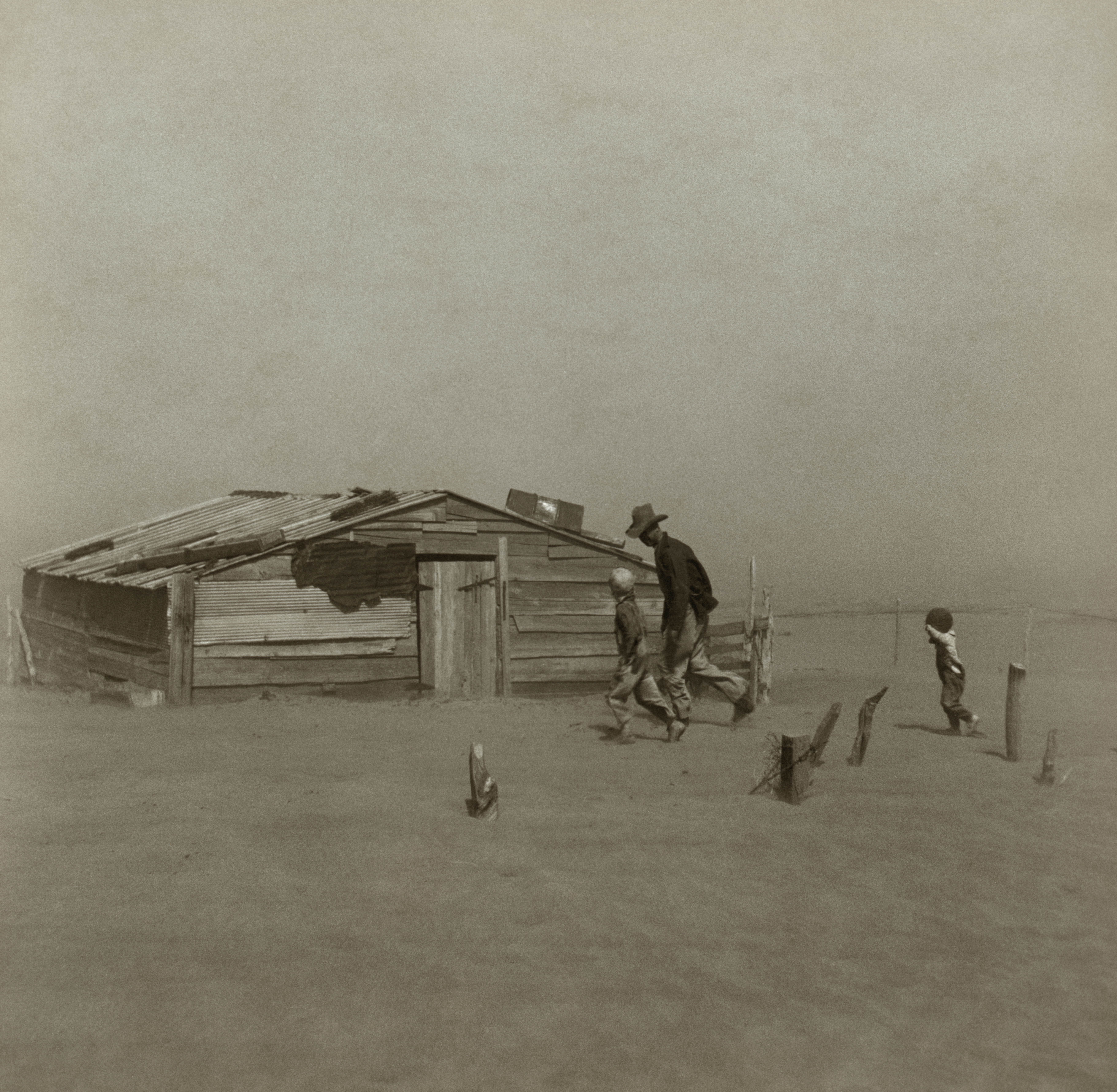 Massive dust storm approaching a farm during the 1930s Dust Bowl