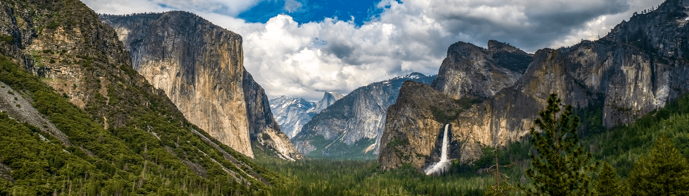 Hikers on trail with view of Half Dome in Yosemite National Park