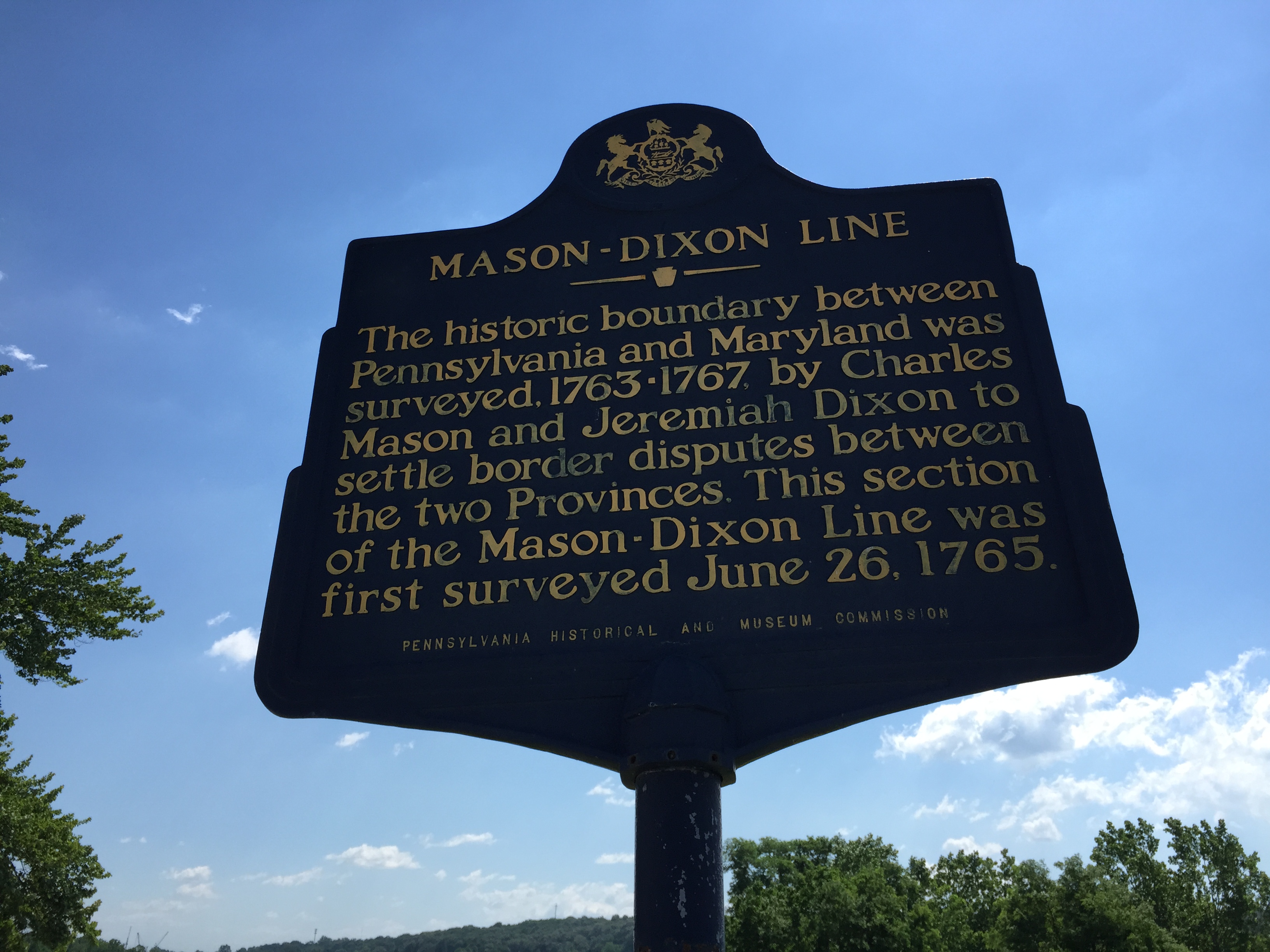 Historical stone marker of the Mason-Dixon Line with state boundary inscription