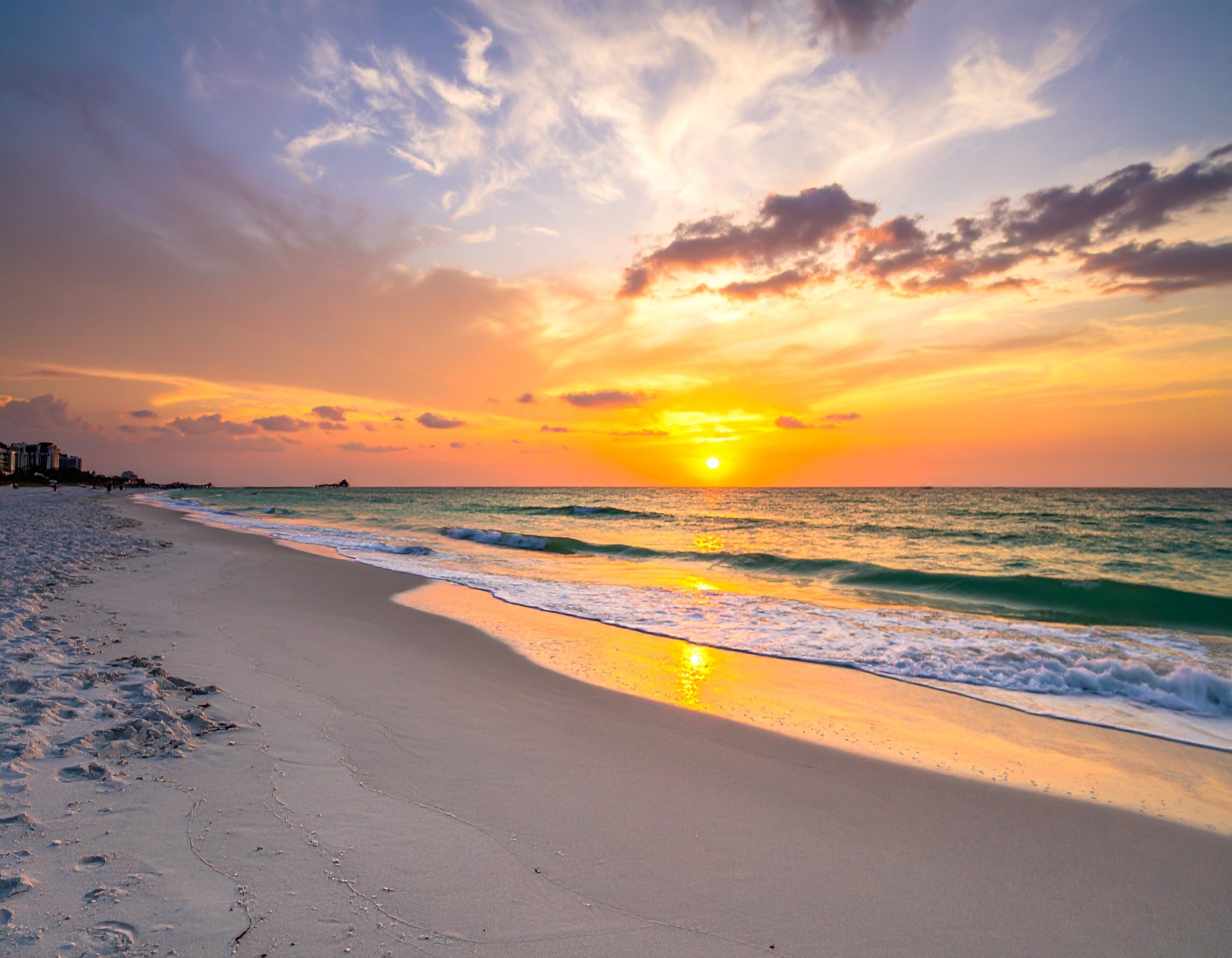 Stunning sunset view of Clearwater Beach with white sand and turquoise water