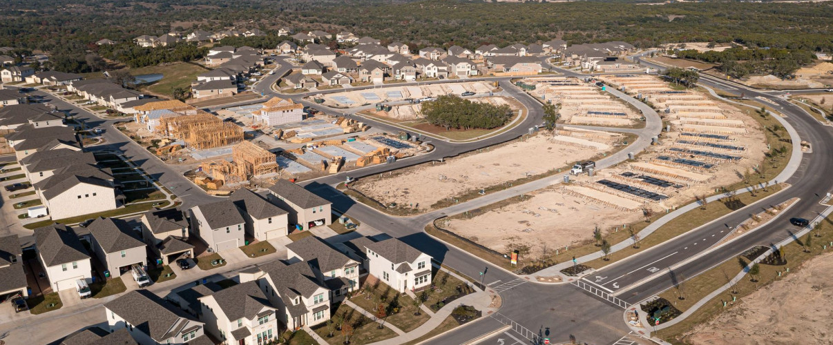 Aerial view of expanding suburban development in Texas with new construction homes