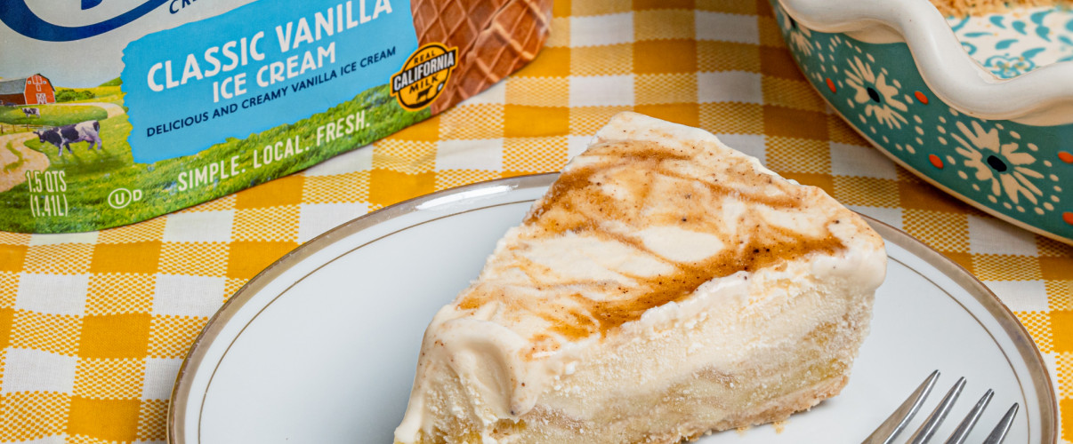 Freshly baked golden apple pie with a scoop of vanilla ice cream on top