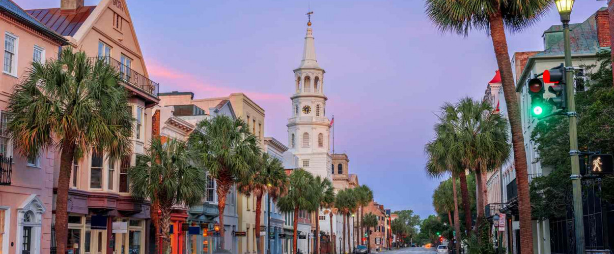 Colorful historic buildings along Charleston's waterfront with palm trees
