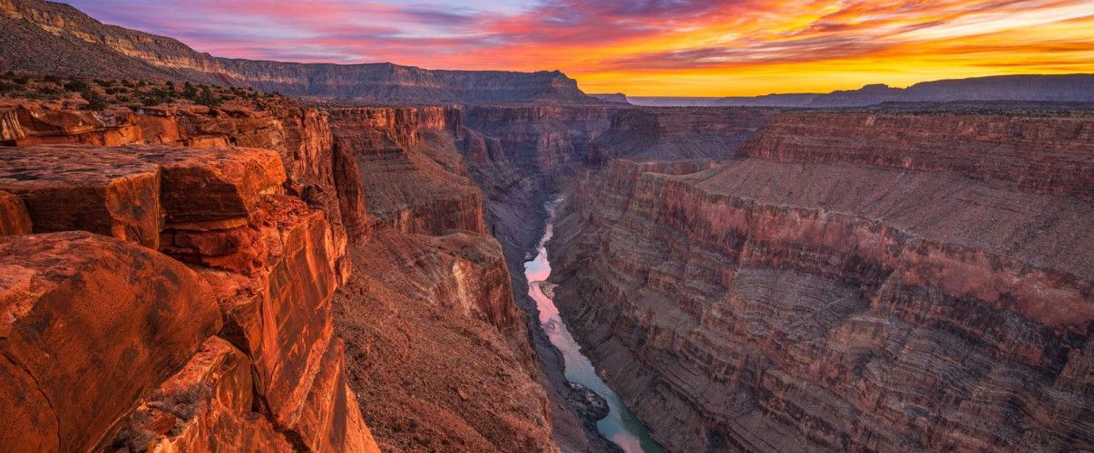 Majestic view of the Grand Canyon at sunset with colorful stratified rock layers