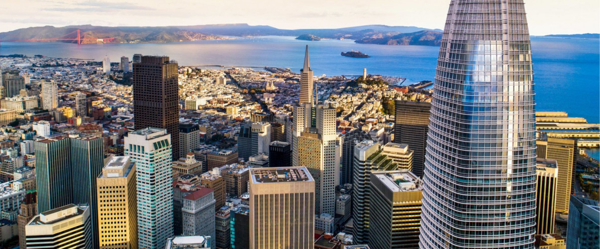 Modern tech office with San Francisco skyline visible through large windows