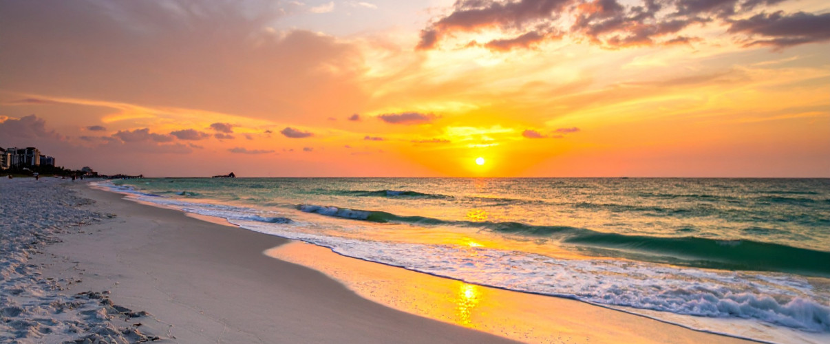 Stunning sunset view of Clearwater Beach with white sand and turquoise water