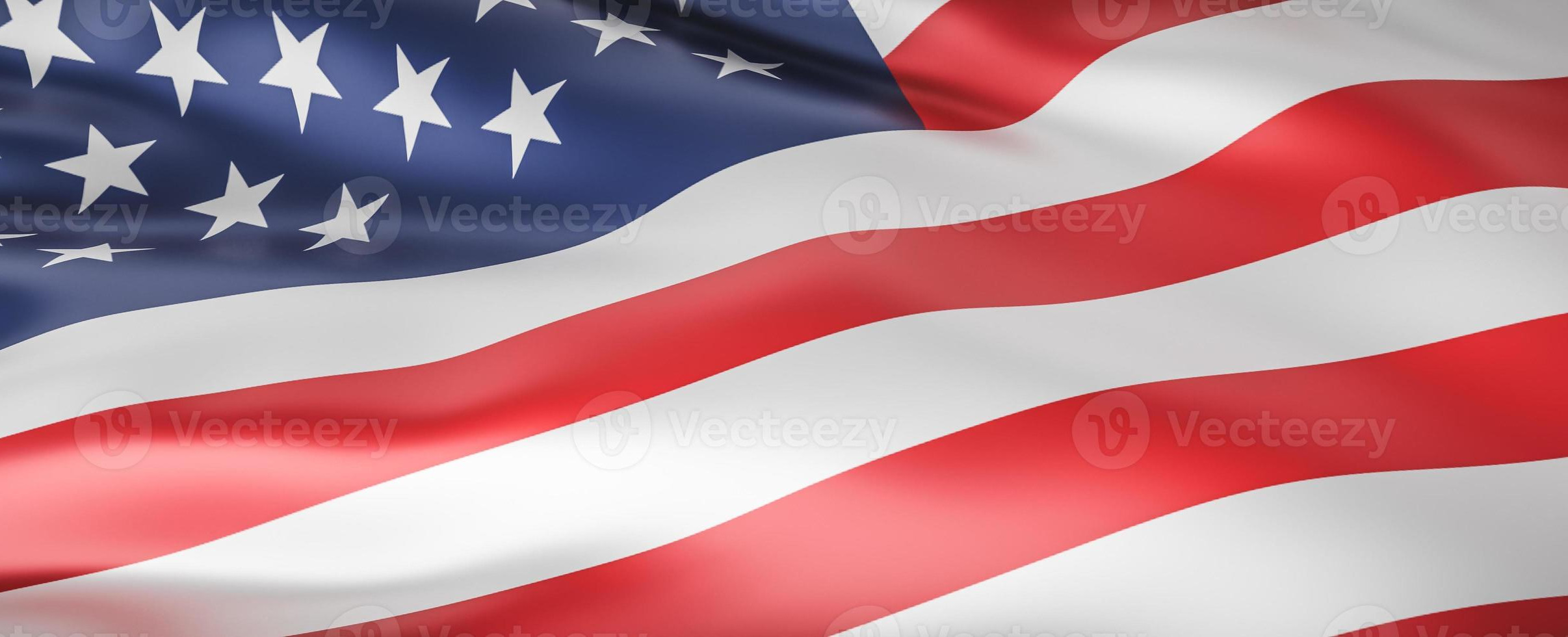 A vibrant state flag waving against a blue sky