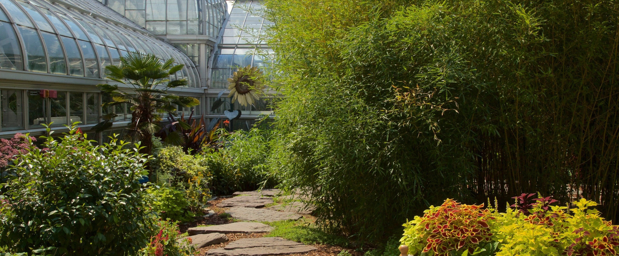 Aerial view of expansive botanical garden with colorful flower beds and winding pathways