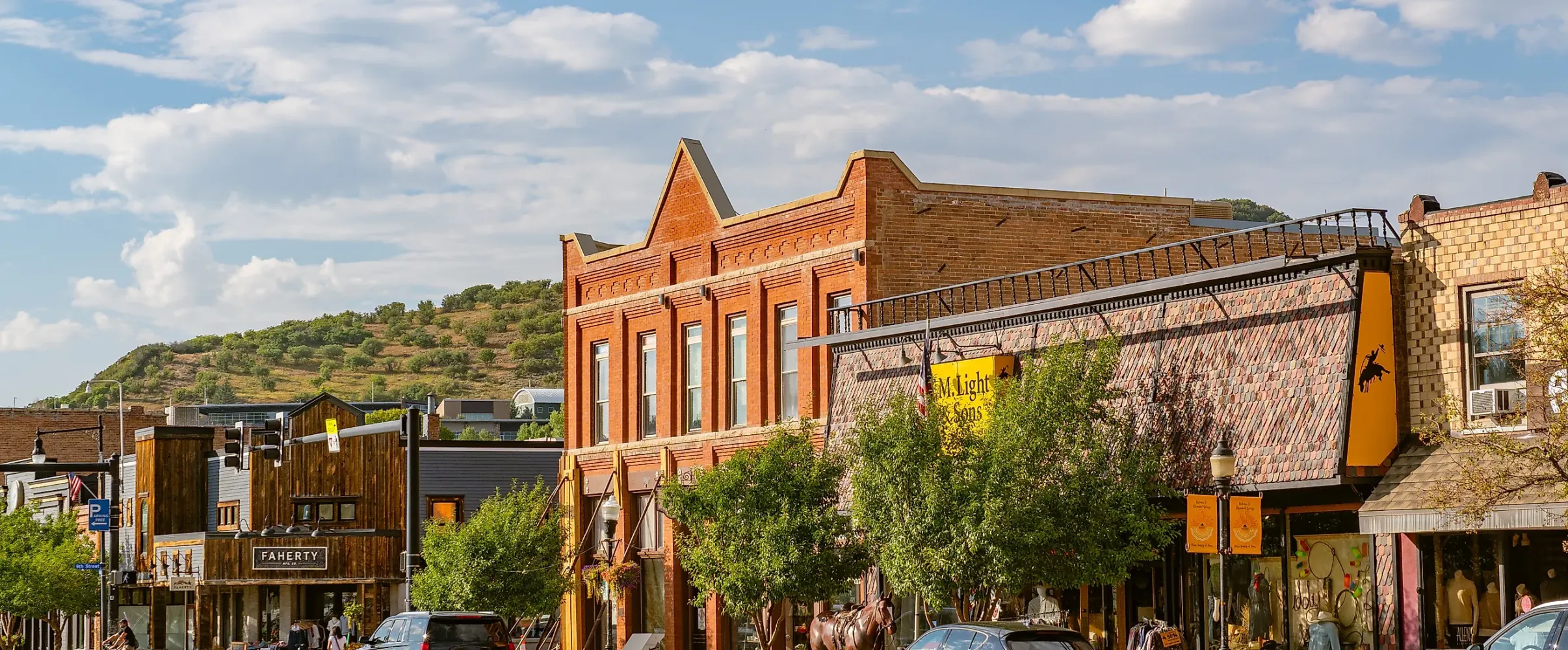 Tree-lined main street in charming American small town with historic storefronts