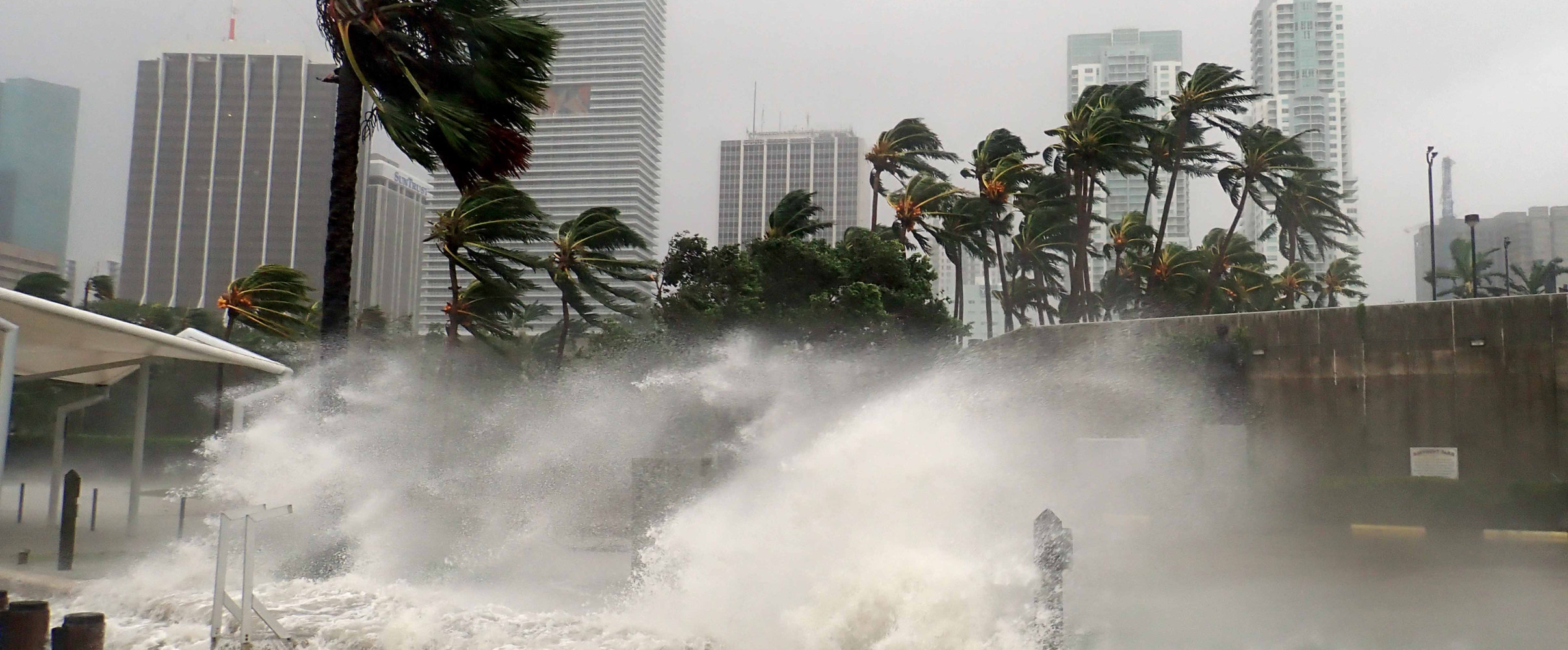 Aerial view of coastal city experiencing severe flooding with submerged streets and buildings