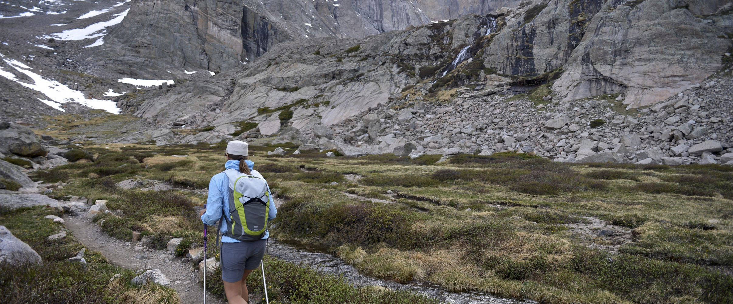 Hikers on a mountain trail in Colorado's Rocky Mountains with scenic panoramic views