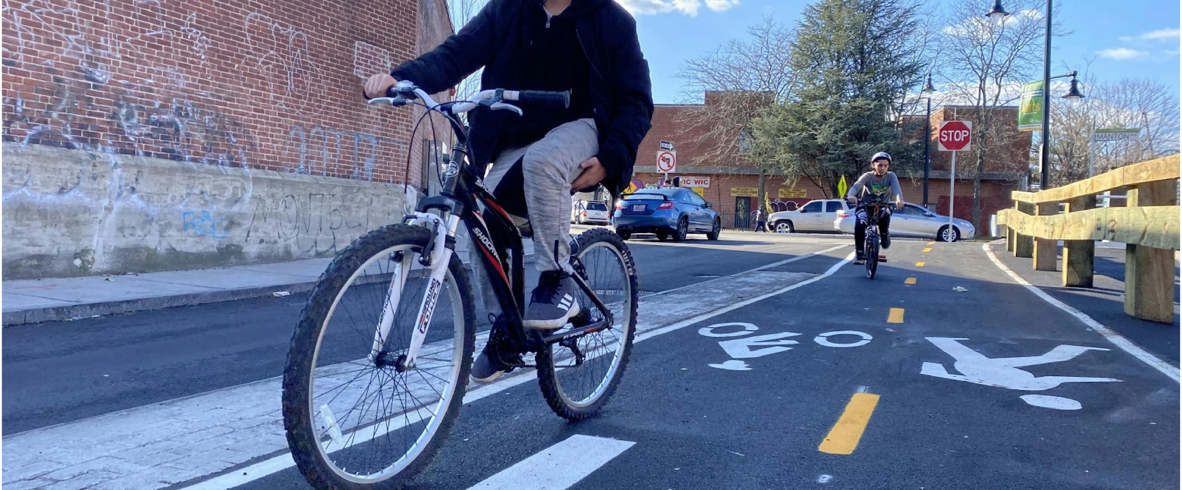 Cyclists on protected bike lane Cyclists riding on a protected bike lane in an urban setting