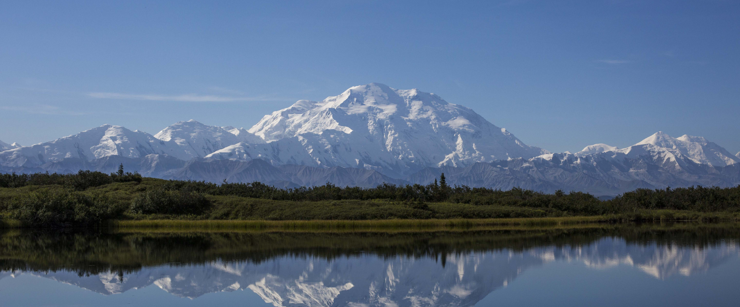 Denali mountain Alaska peak Majestic snow-capped Denali mountain (formerly Mount McKinley) rising above clouds in Alaska