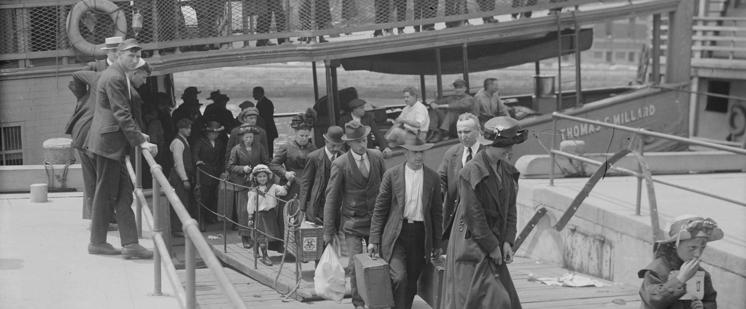 Ellis island immigration station historic photo Historic black and white photograph of Ellis Island Immigration Station with crowds of immigrants