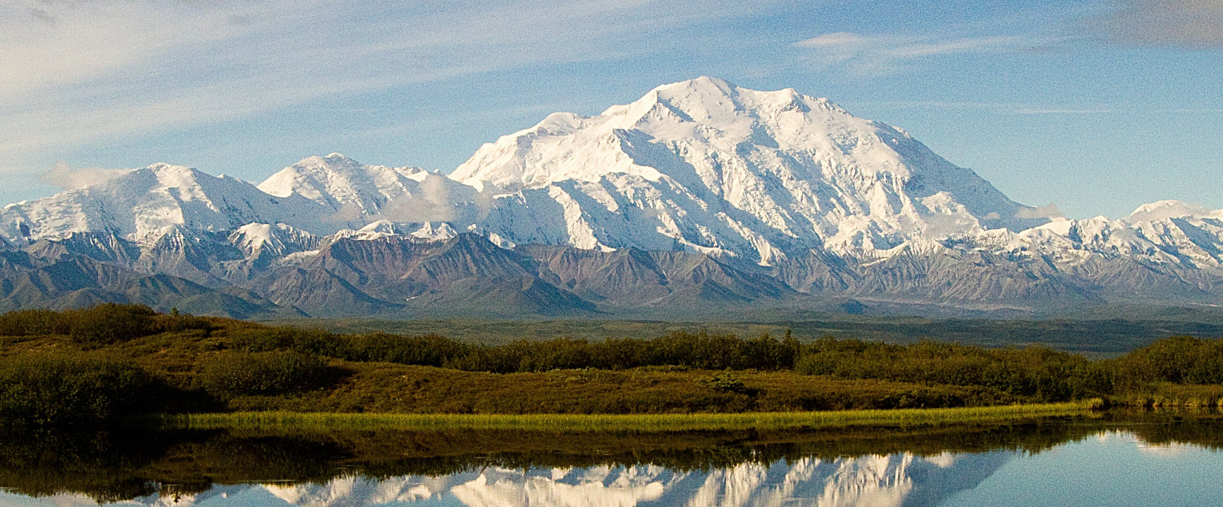 Majestic snow-capped Denali mountain (formerly Mount McKinley) rising above clouds in Alaska