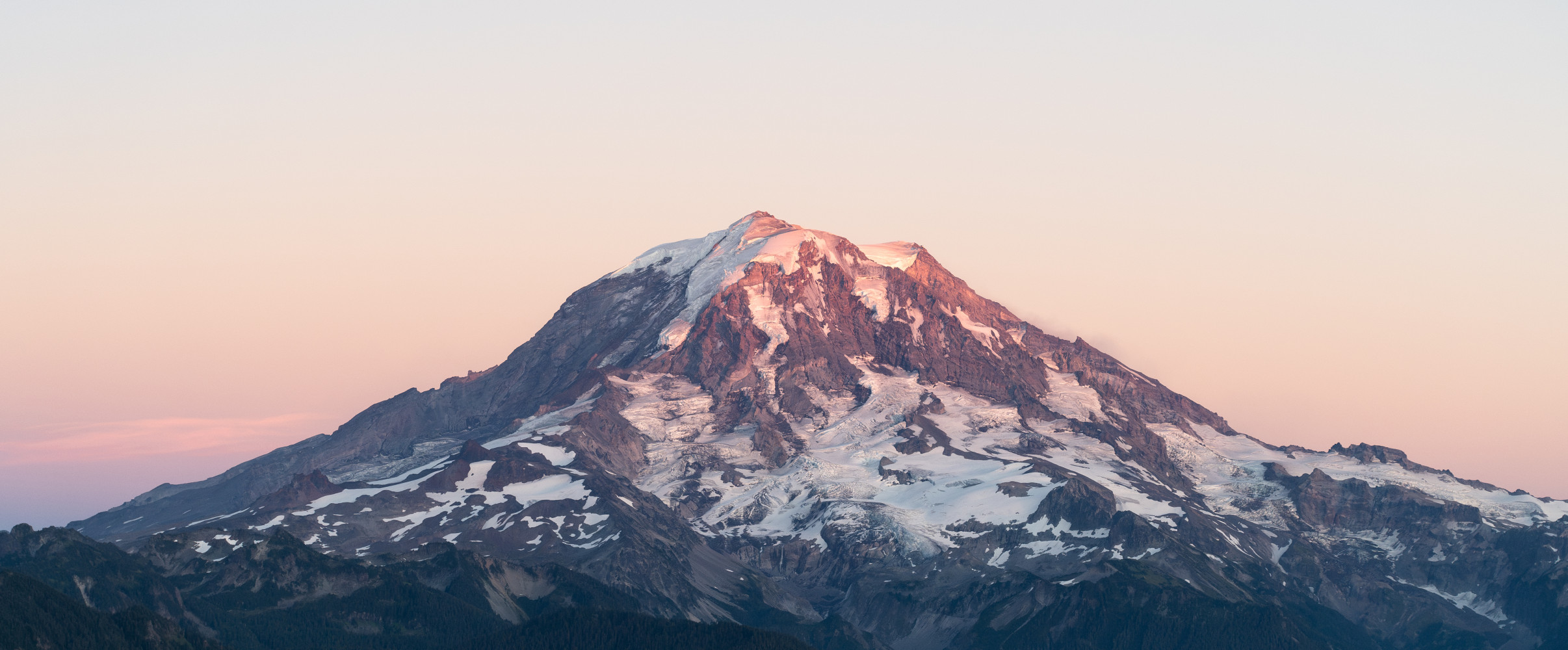 Mount Rainier volcano Snow-capped Mount Rainier volcano rising majestically against blue sky