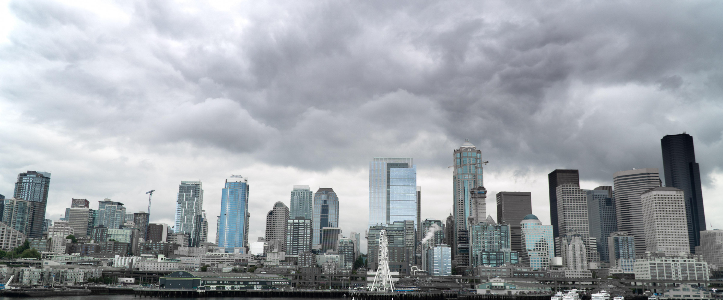 Rainy Seattle skyline with Space Needle visible through fog and precipitation