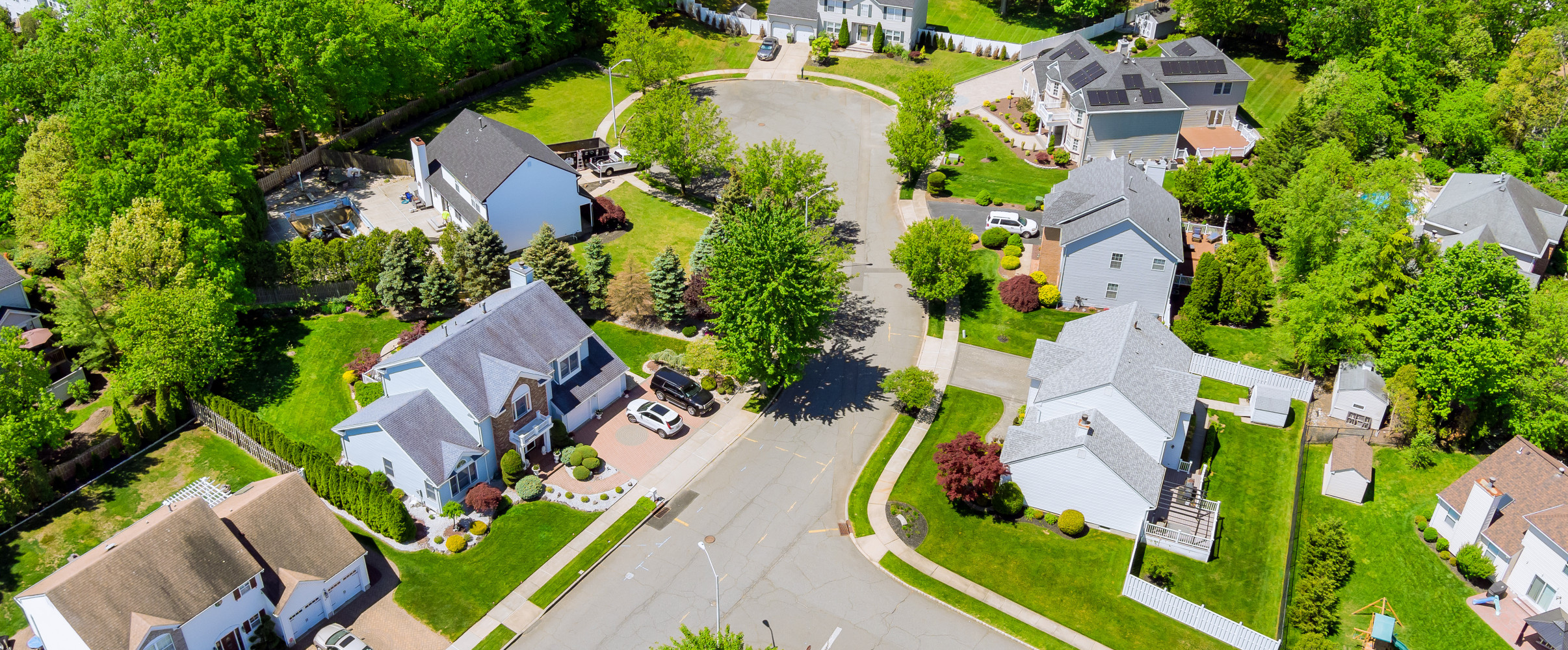 Aerial view of suburban neighborhood with single-family homes