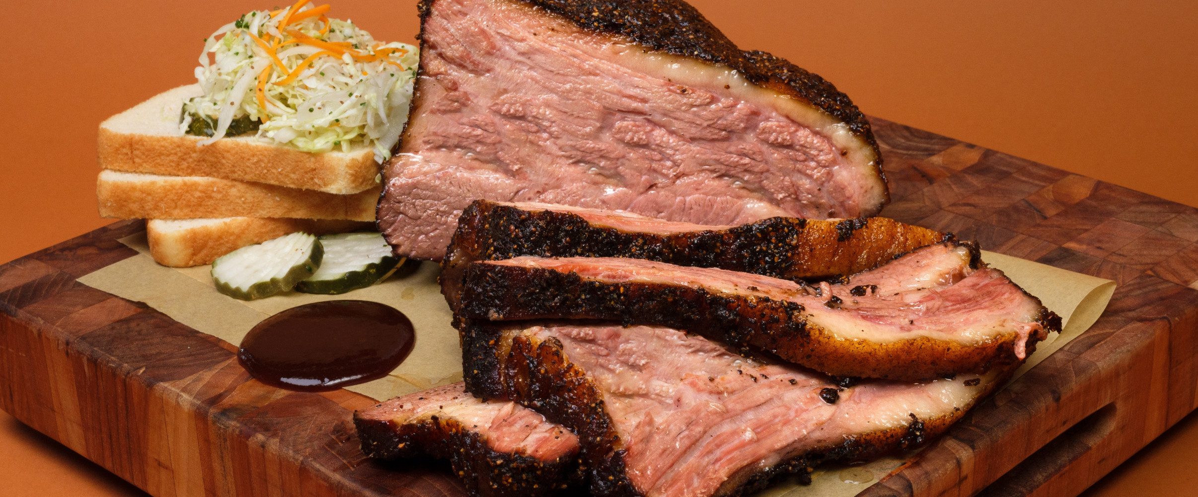 Texas barbecue brisket Juicy sliced brisket with smoke ring served on butcher paper at a Texas barbecue joint
