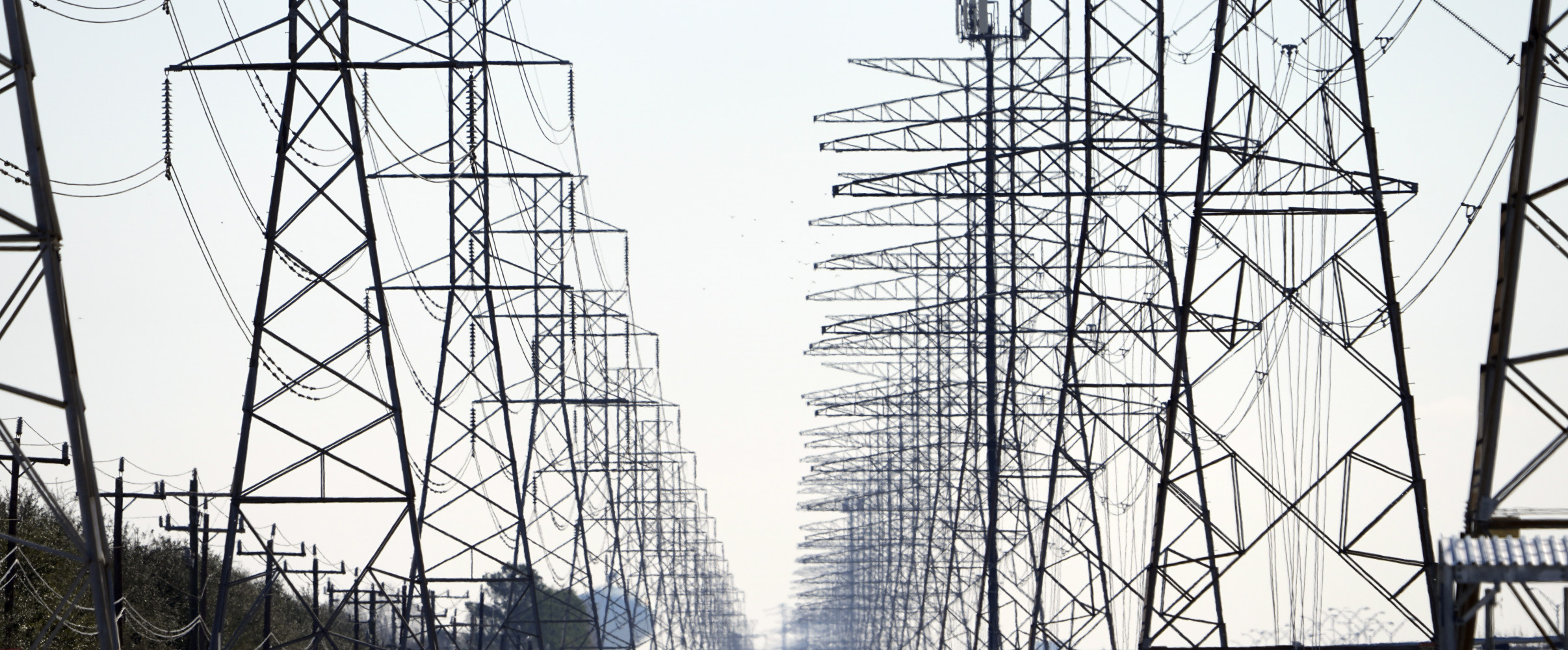 Texas power grid High voltage transmission lines crossing the Texas landscape with a sunset in the background