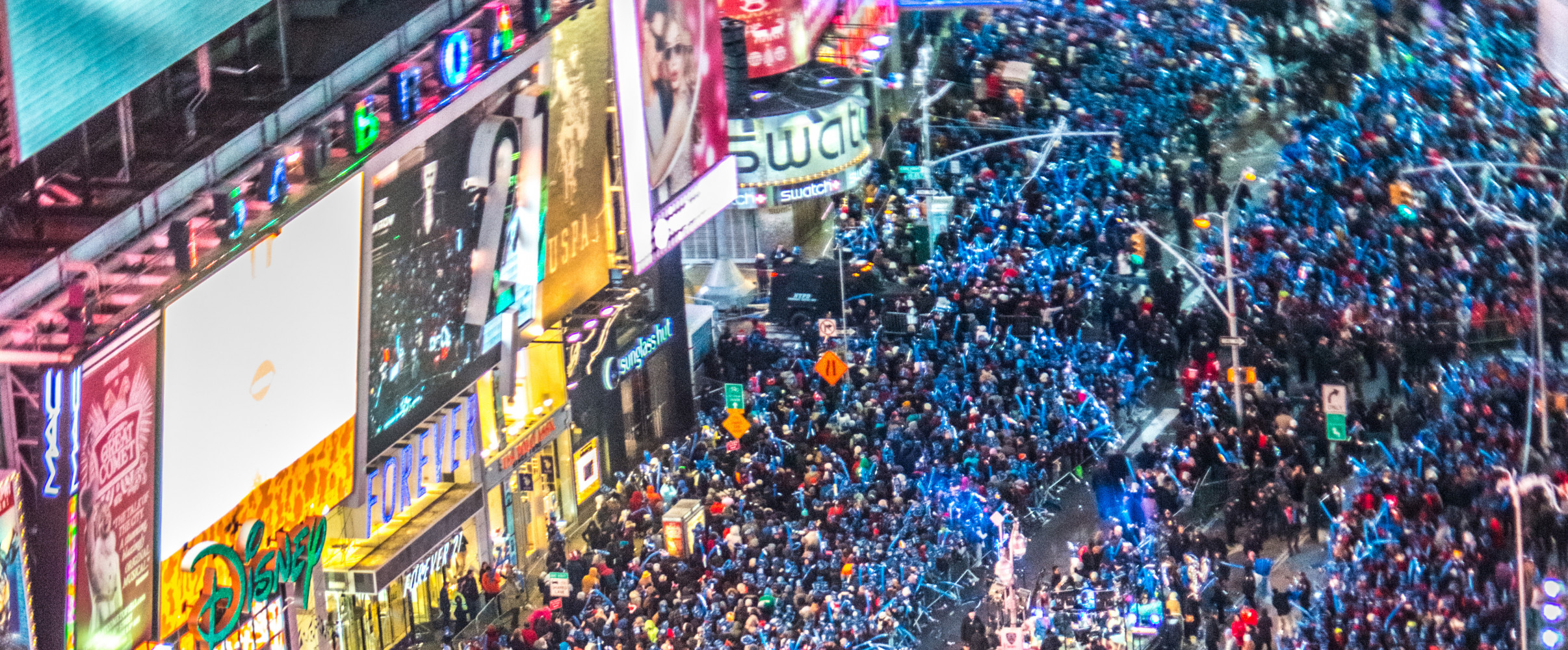 Times Square New Year's Eve celebration Crowd gathered in Times Square watching the iconic ball drop on New Year's Eve