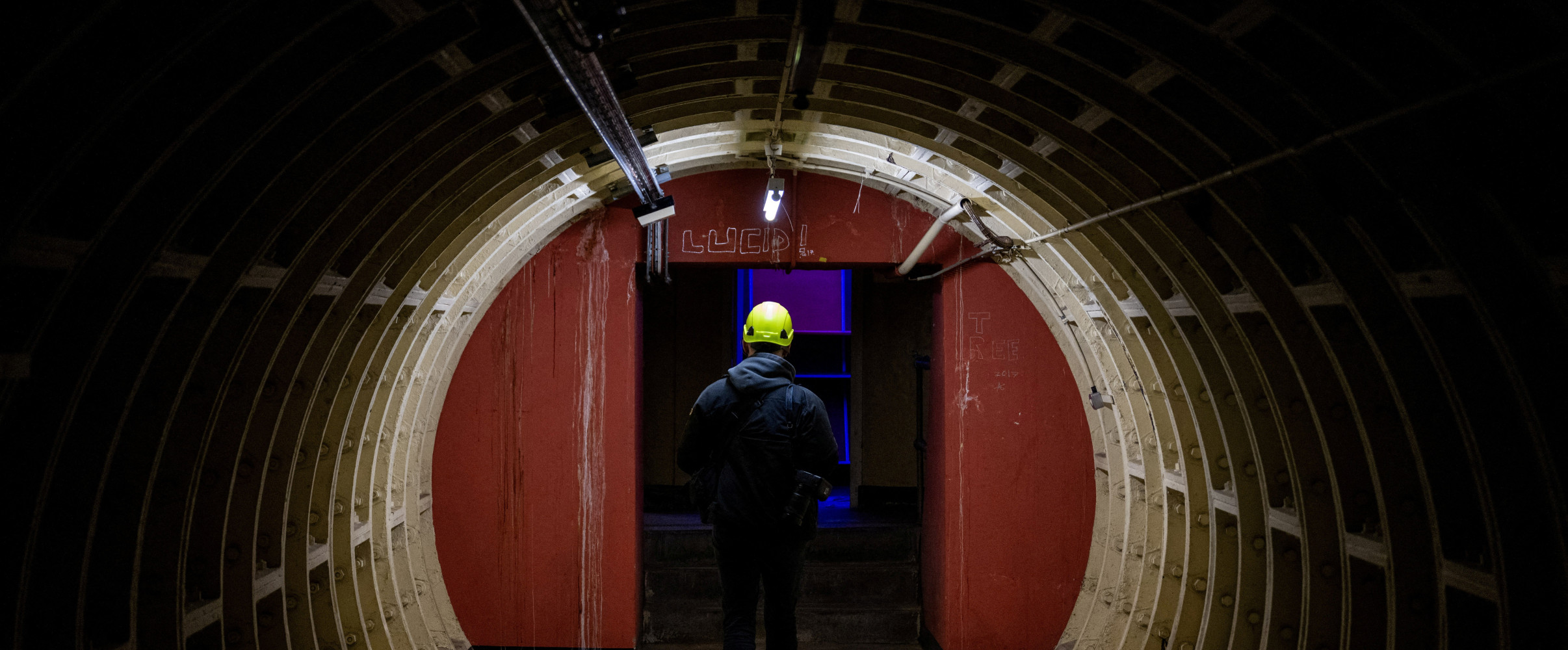 Illuminated underground tunnel with historic stone architecture