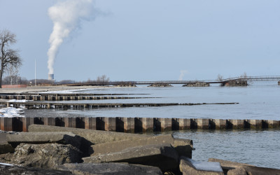 Aerial view of industrial shoreline along the Great Lakes with cargo ships and manufacturing facilities
