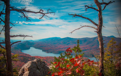 Hikers walking along a scenic ridge on the Appalachian Trail with mountains in the background