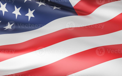 A vibrant state flag waving against a blue sky