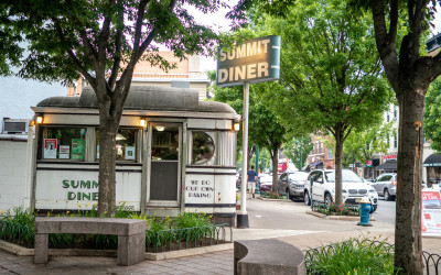 Exterior of a classic stainless steel New Jersey diner with neon signs