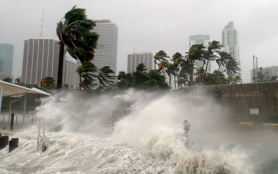 Aerial view of coastal city experiencing severe flooding with submerged streets and buildings