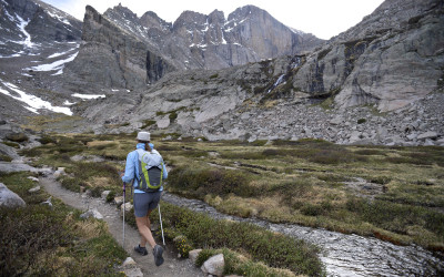 Hikers on a mountain trail in Colorado's Rocky Mountains with scenic panoramic views