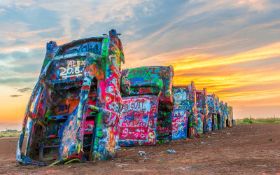 Colorful vintage Cadillacs buried nose-down in the Texas desert at Cadillac Ranch