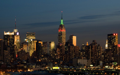 Illuminated Empire State Building standing tall in the New York City skyline at night