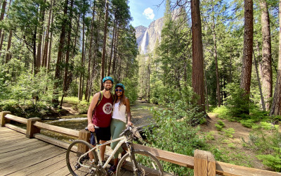 Hikers on trail with view of Half Dome in Yosemite National Park