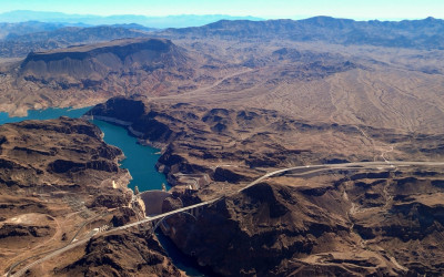 Aerial view of Hoover Dam spanning Black Canyon with Lake Mead reservoir