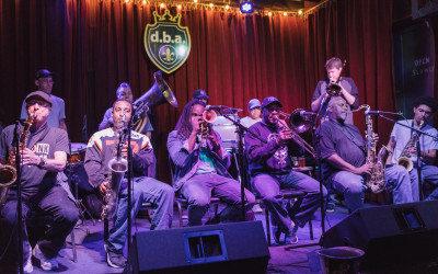 Jazz musician playing saxophone in a dimly lit New Orleans club