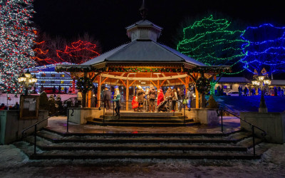 Bavarian-style buildings in Leavenworth, Washington decorated with thousands of Christmas lights against a snowy backdrop
