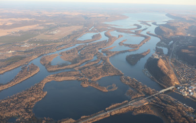 Aerial view of the winding Mississippi River flowing through green landscape