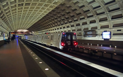 Modern subway train at an urban station platform with passengers