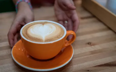 Barista creating intricate latte art in a cozy Portland coffee shop