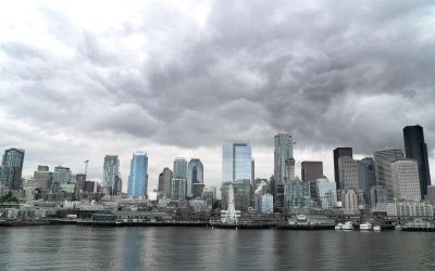 Rainy Seattle skyline with Space Needle visible through fog and precipitation