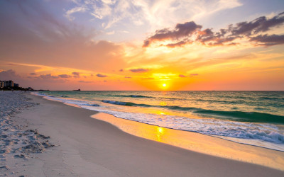 Stunning sunset view of Clearwater Beach with white sand and turquoise water