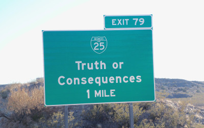 Welcome sign for Truth or Consequences, New Mexico with desert landscape in background