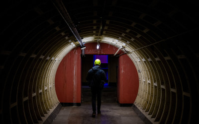 Illuminated underground tunnel with historic stone architecture