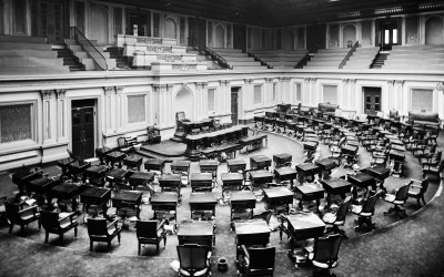 The United States Senate chamber with empty seats and the American flag
