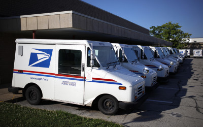 USPS mail delivery truck on residential street