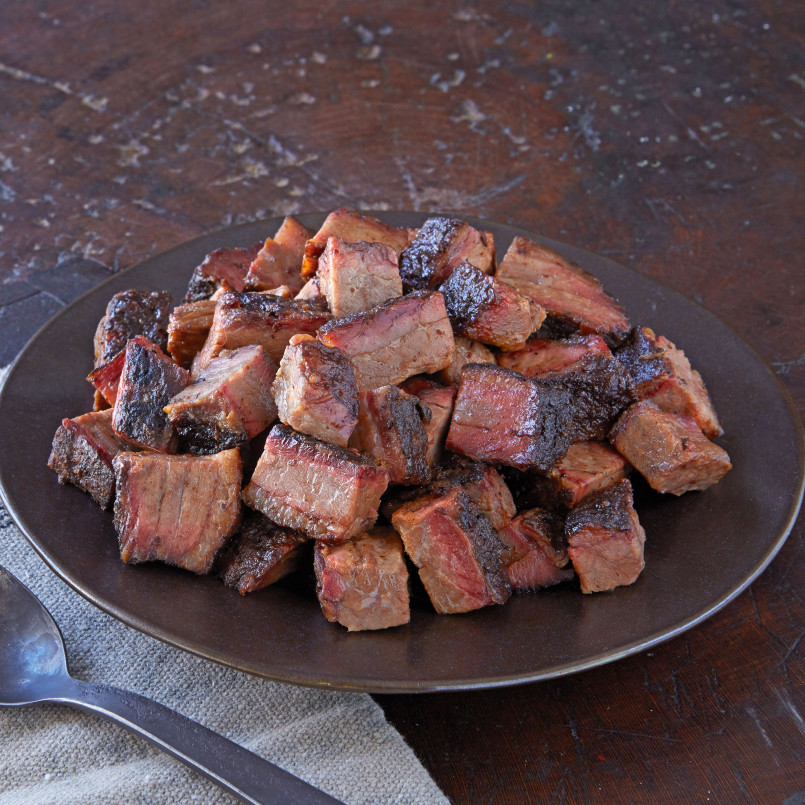A plate of charred, cubed burnt ends from a Kansas City barbecue restaurant
