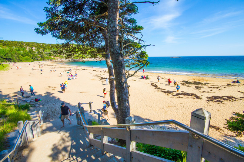 Acadia National Park Sand Beach Maine Sand Beach at Acadia National Park surrounded by rocky cliffs and pine forests